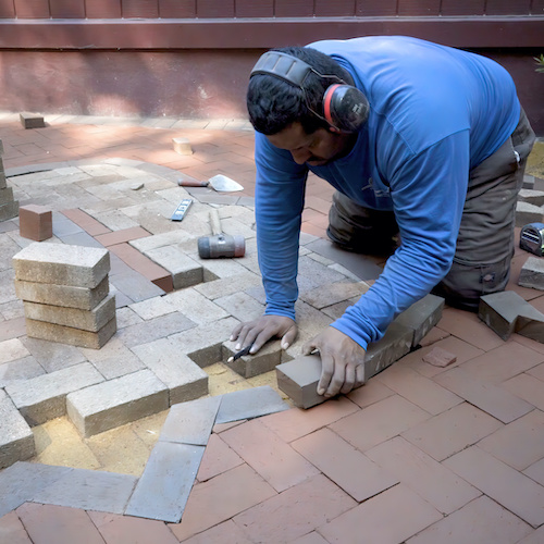 man doing backyard paver installation for luxe pavers coral springs