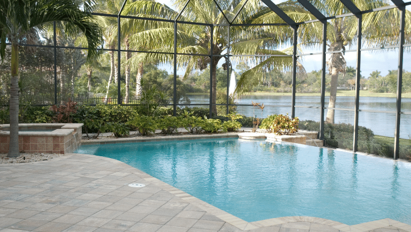 backyard pool and pavers in coral springs in a covered screen patio